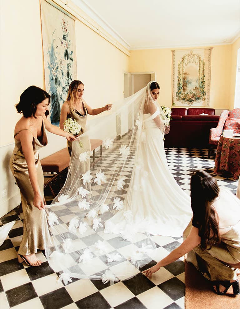 bridal party holding bride veil