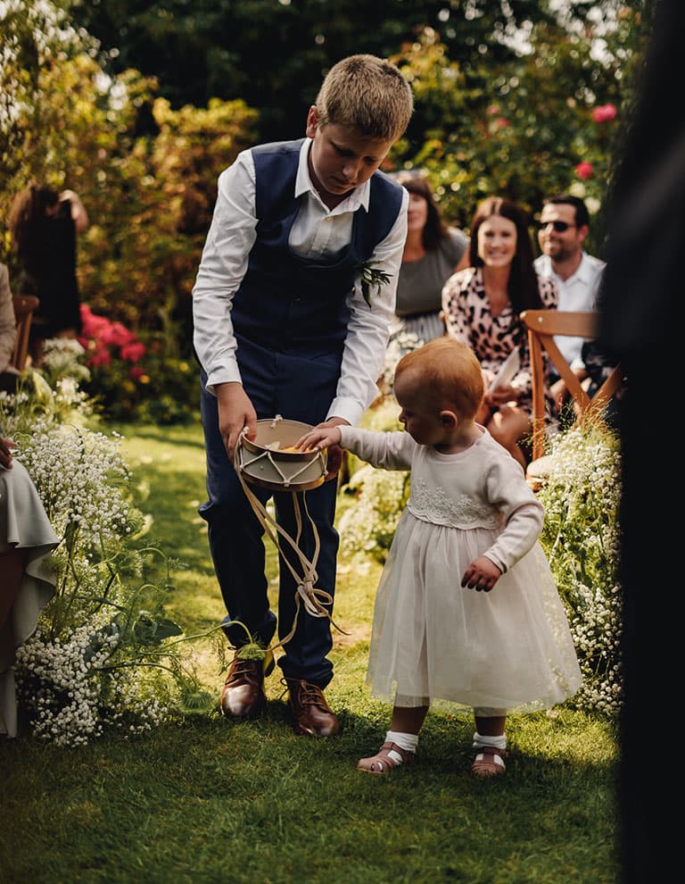 flower girl walking in backyard wedding