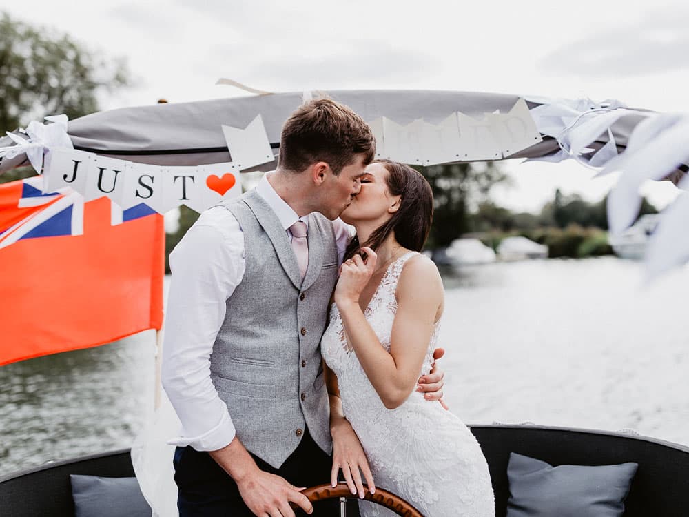 bride and groom boat kiss