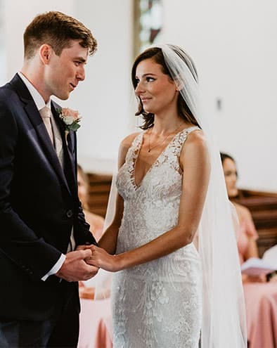 bride and groom saying their vows in the church