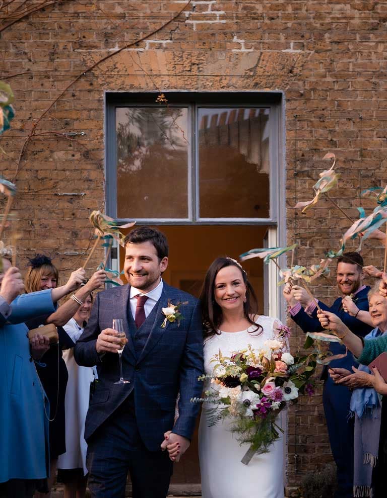 Sophie and Mike walk hand in hand celebrating