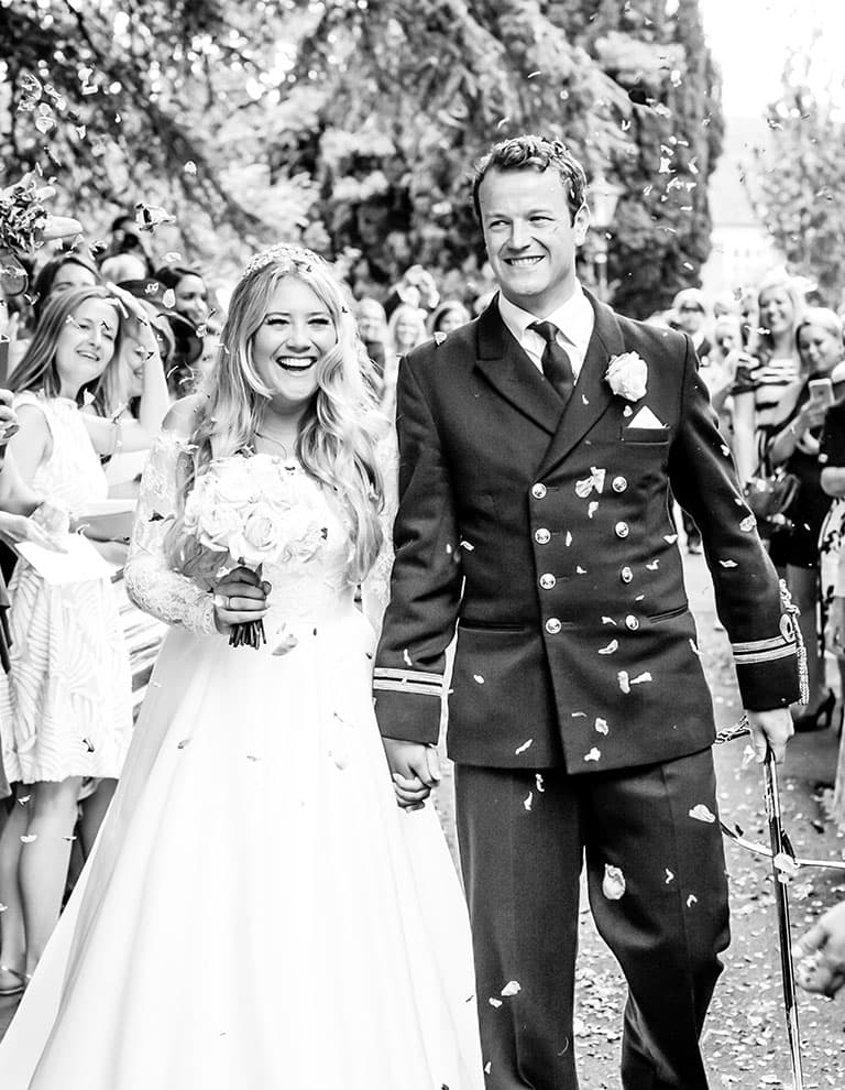 Traditional English Wedding: married couple exists church after the ceremony