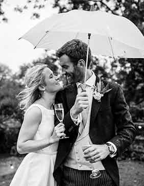 wedding couple under umbrella