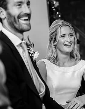 married couple laughing at reception