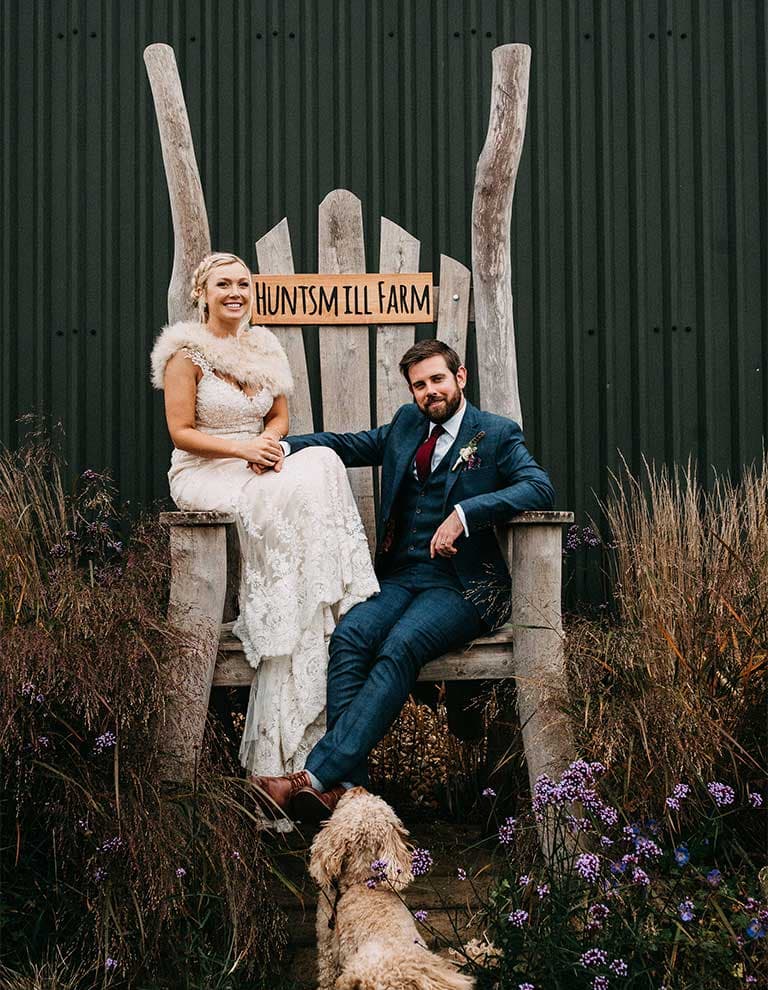 Leanne and Jack sit on rustic chair at Huntsmill Farm