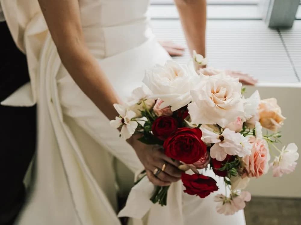 bridal flower bouquet with cream and red flowers