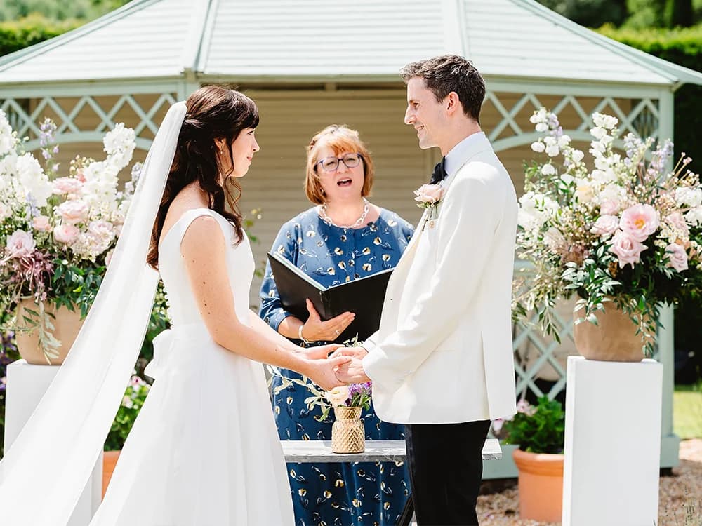 bride and groom next to wedding altar flower decoration