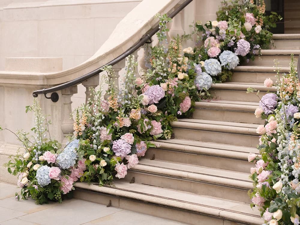 A pastel floral decoration of entryway leading to wedding venue