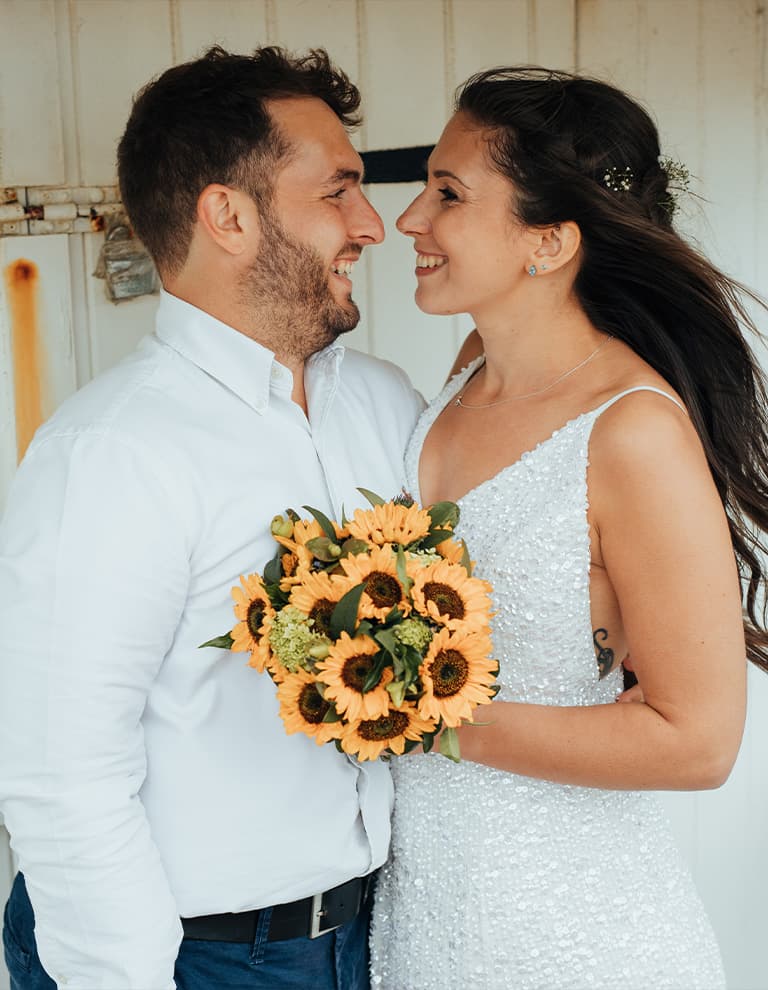 a bride and groom celebrate at their beach wedding
