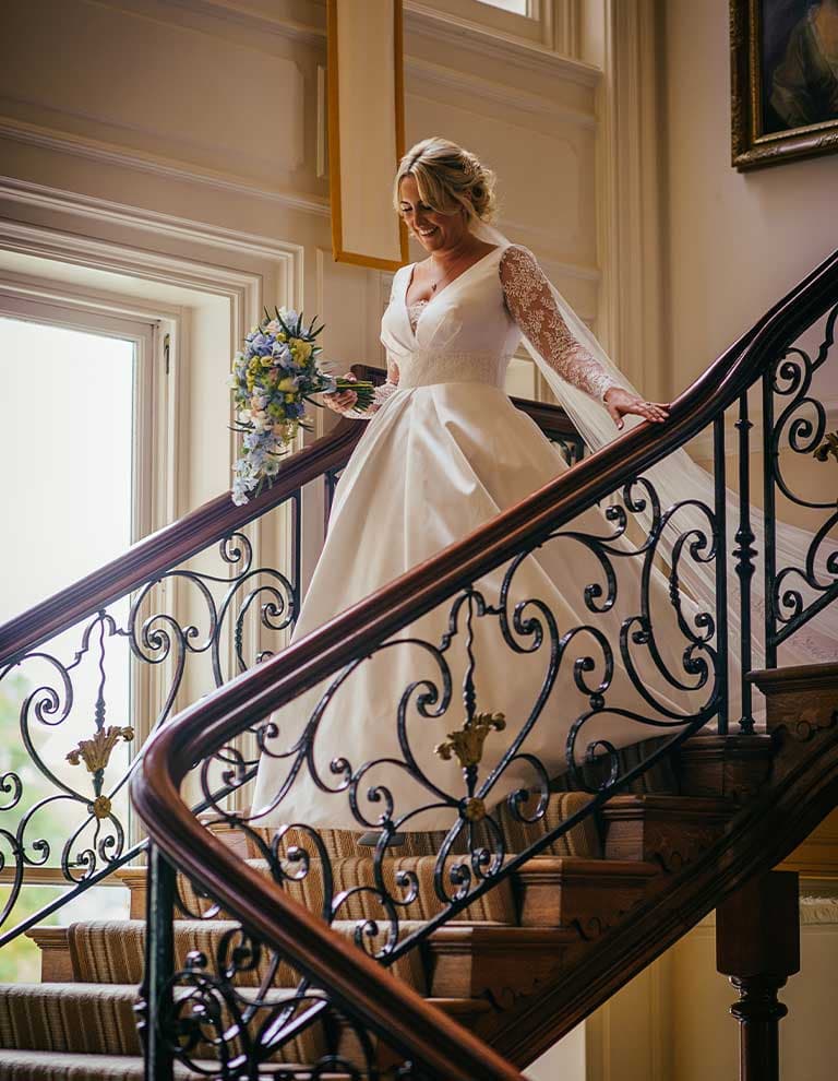 bride Annie walks down the stairwell