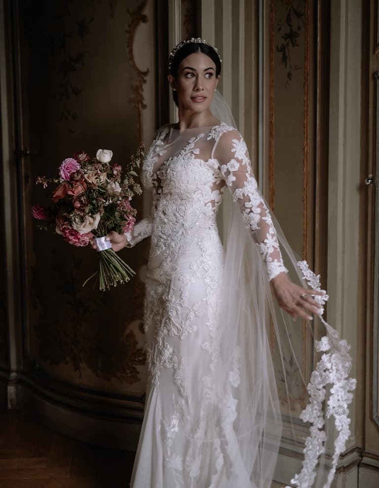 Meighan in romantic lace wedding dress with wedding bouquet