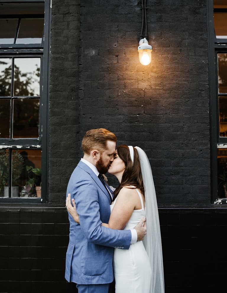 Newlyweds kiss outside Bourne & Hollingsworth