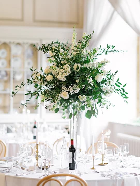 Wedding tables adorned with delicate white décor and floral bouquets