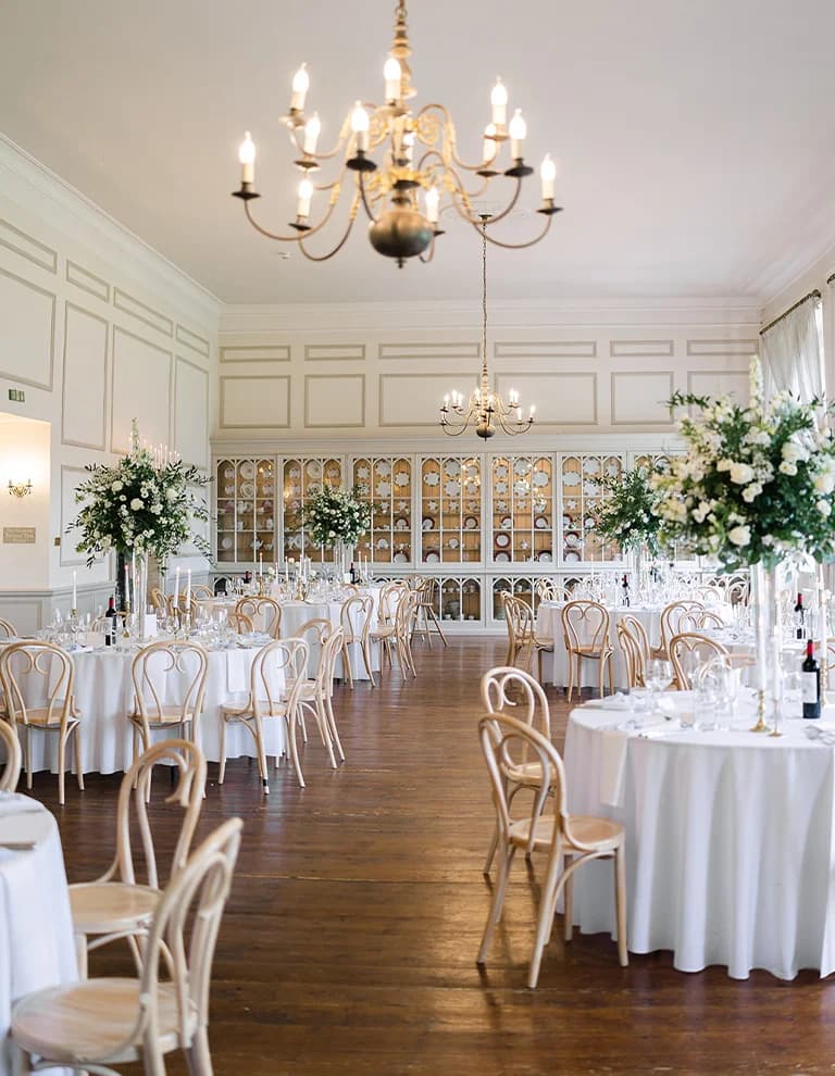 Wedding reception venue filled with whimsically decorated tables and floral arrangements