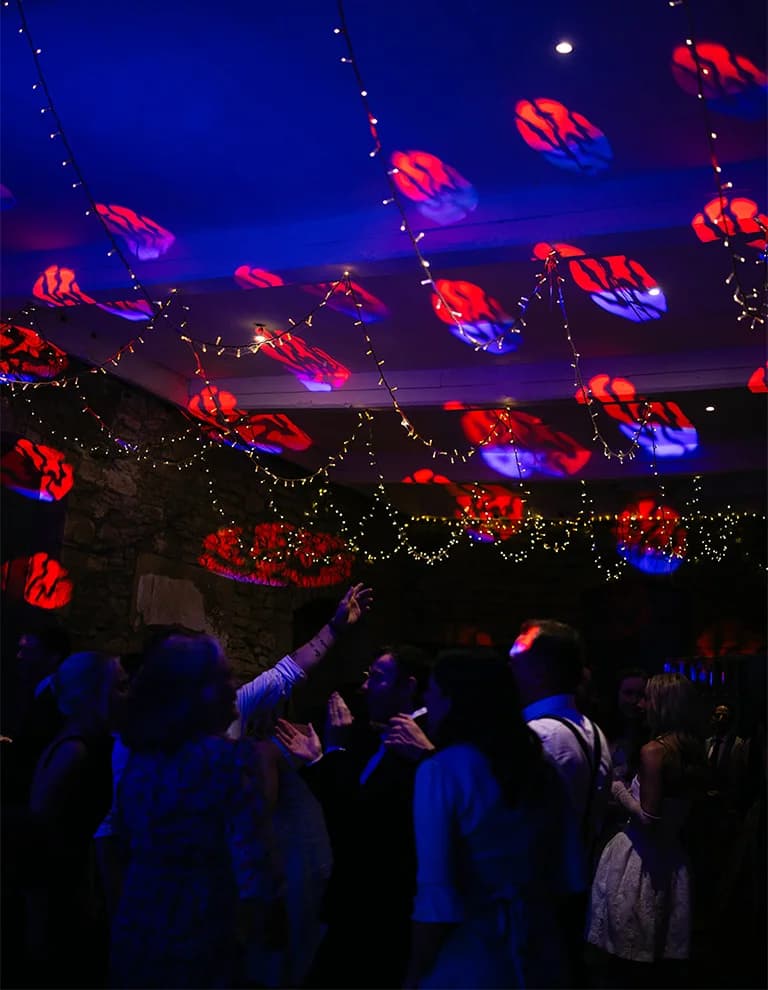 wedding guests dancing to party lights