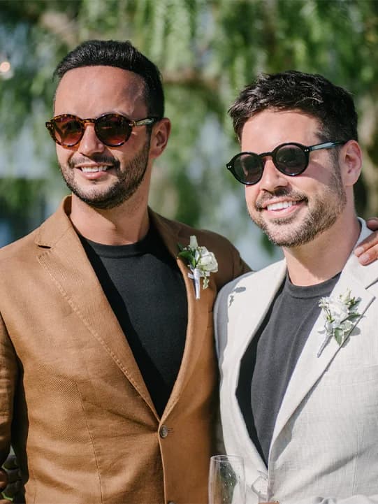 Lucio and Sam wearing linen suits in neutral tones