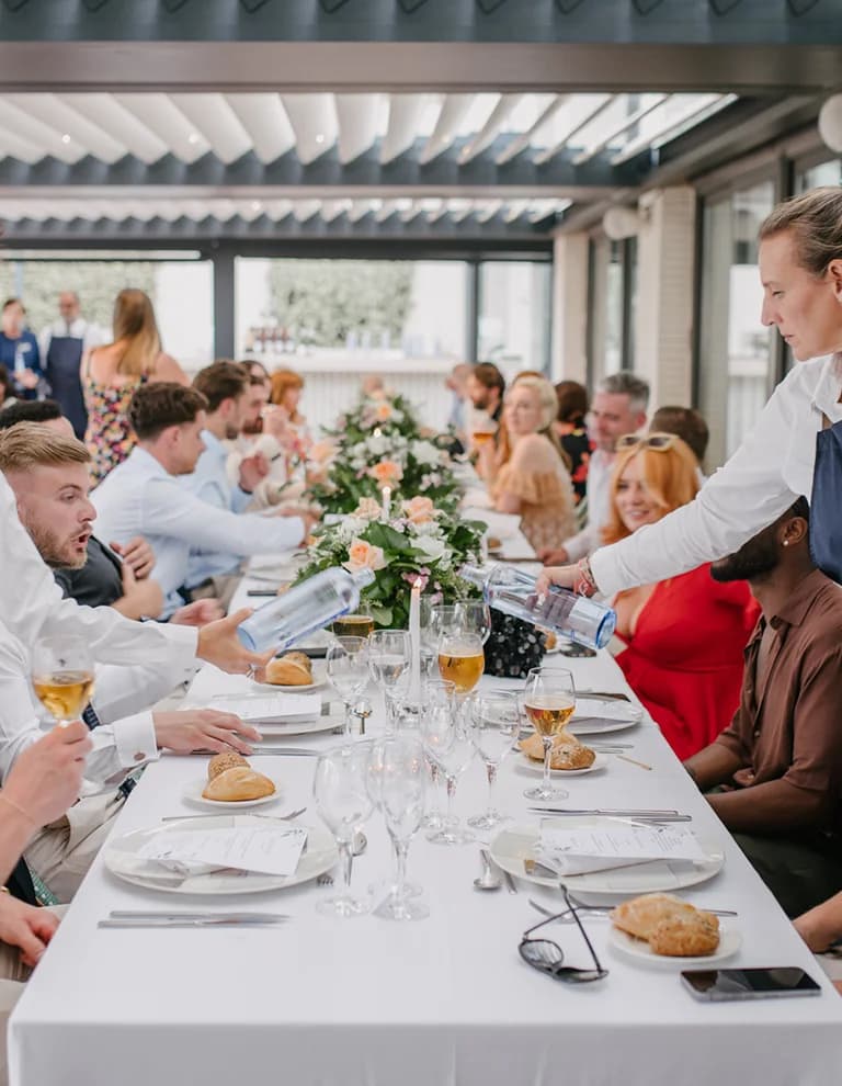 wedding guests are seated for wedding dinner