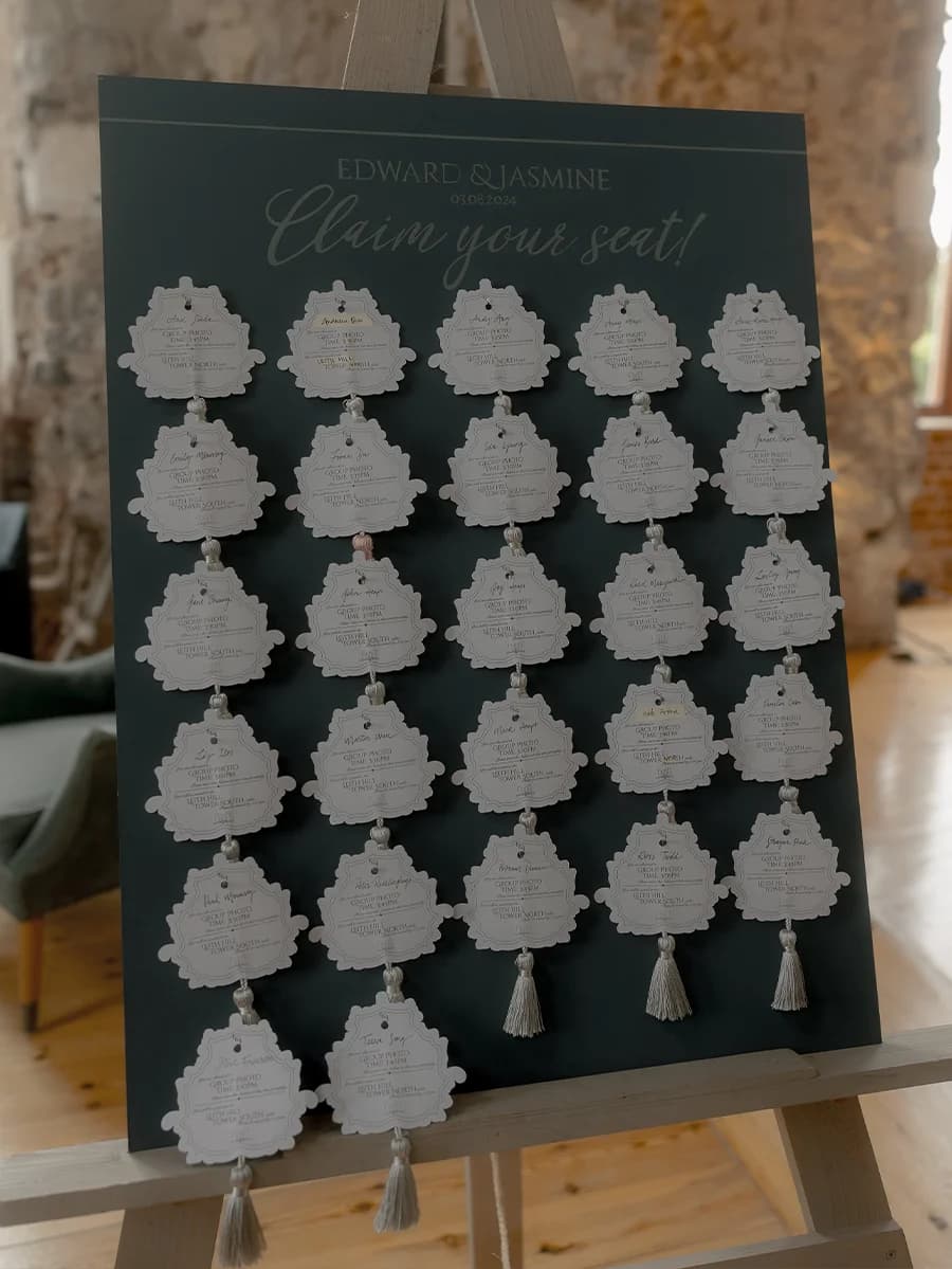 A seating plan board with handcrafted seating plan cards with tassels