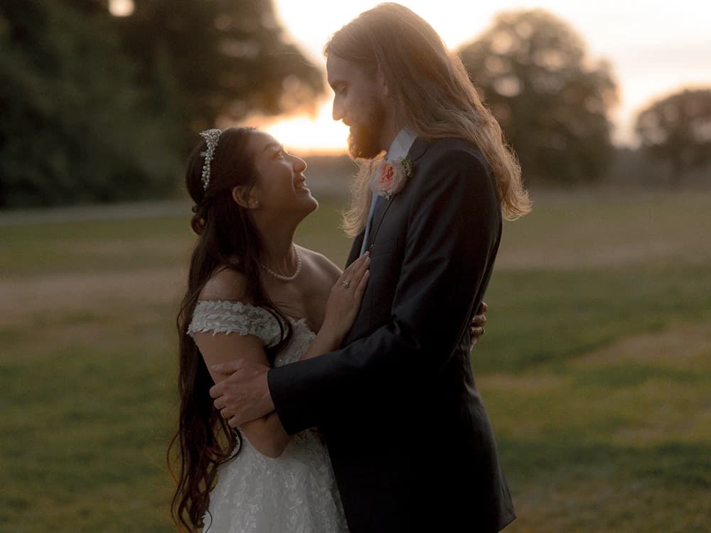 Bride and groom hug during the sunset