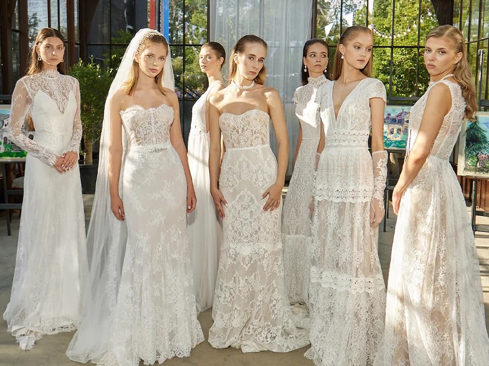 A group of models wearing lace bridal gown