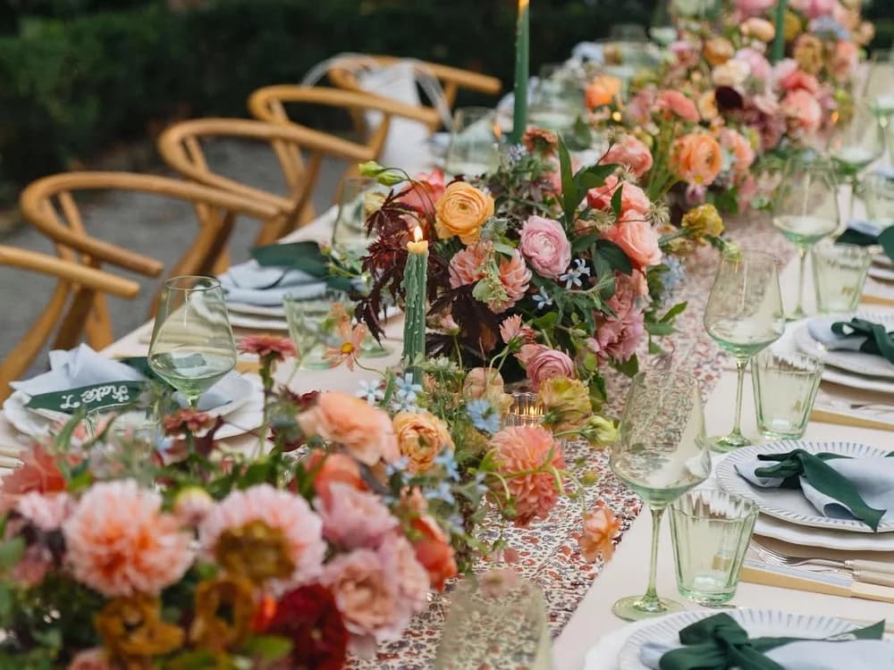 Maximalist wedding decor featuring colourful flower bouquets, mismatched cutlery and colourful glassware