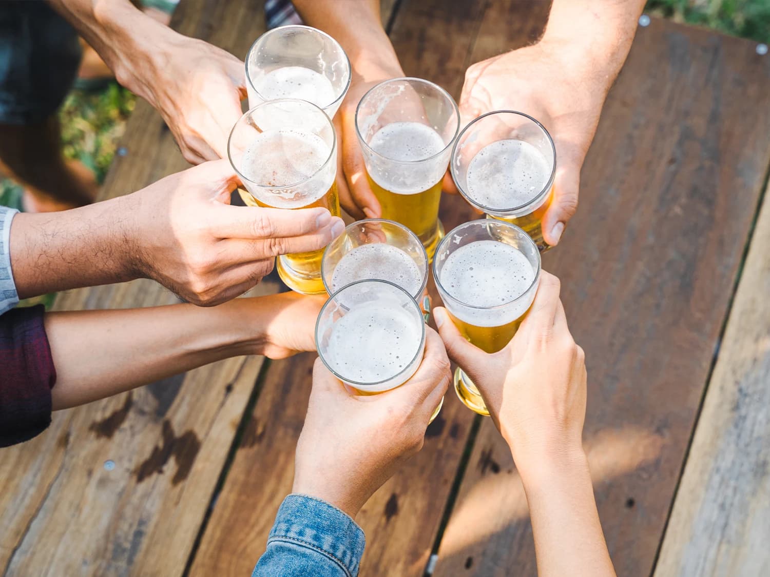 Hands holding beers after beer making workshop