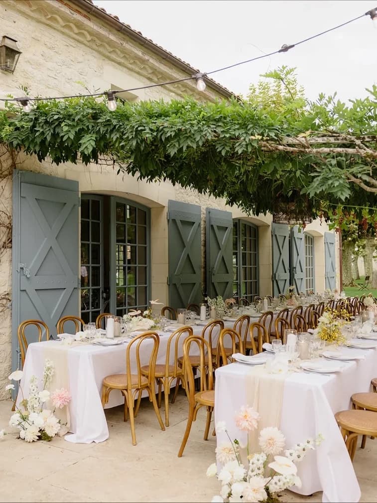 Wedding tables beneath vines at a French villa