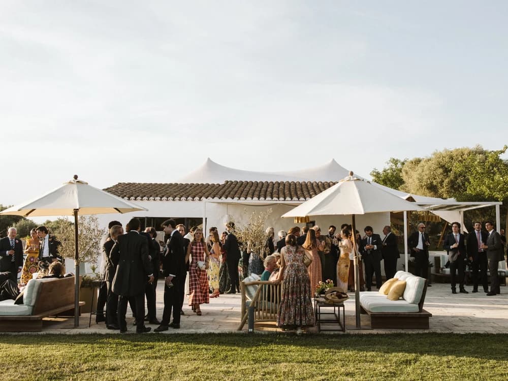 Wedding guests enjoy cocktails on a villa terrace